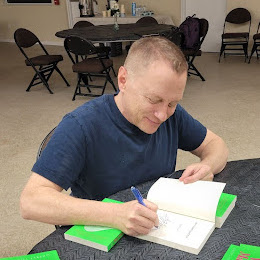 Garret signs copies of his book Why Vibes Matter: Understand Your Energy and Learn How to Use It Wisely